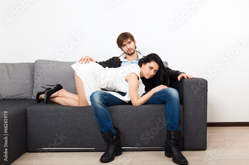 couple on couch flirting, man sexy playful woman