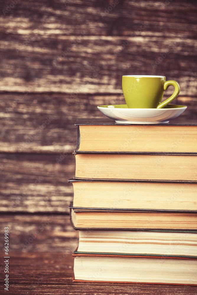 Books and cup of coffee on wooden background. Books and cup of coffee on wooden background.