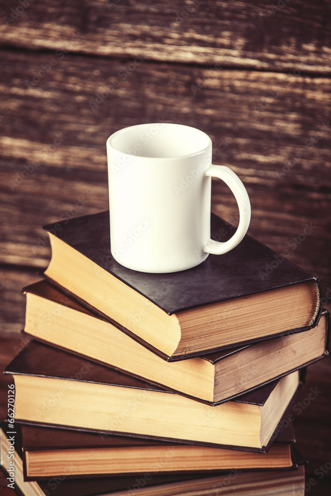 Books and cup of coffee on wooden background. Books and cup of coffee on wooden background.