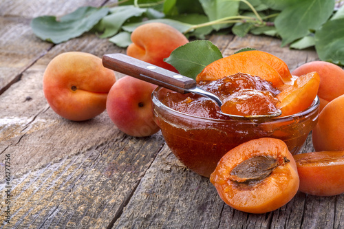Healthy domestic apricot jam on old rustic table