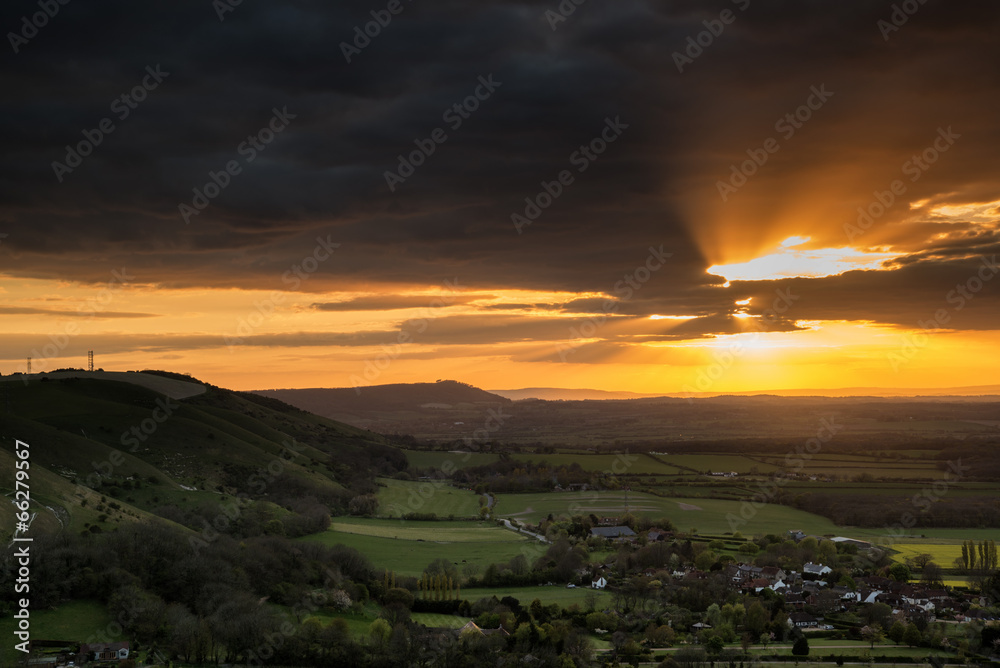 Stunning Summer sunset across countryside landscape with dramati