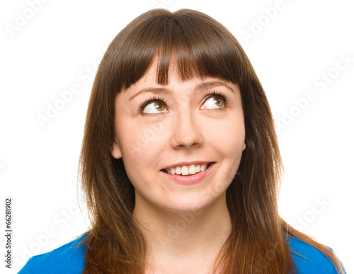 Young happy woman is looking up and smile