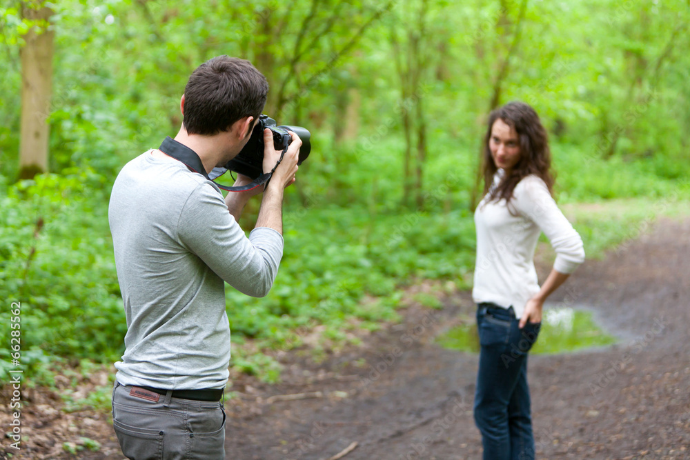 Photographer taking picture of an attractive model Photographer taking picture of an attractive model