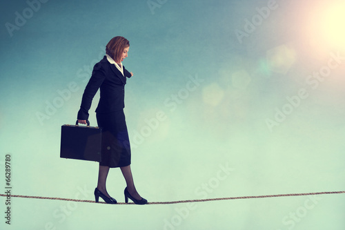 businesswoman on a tightrope