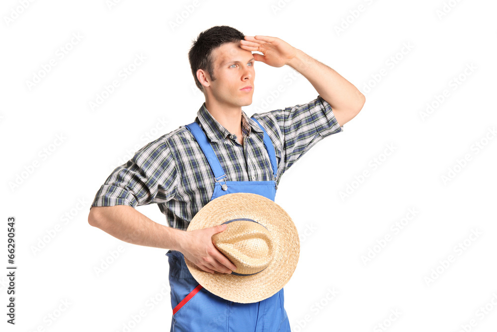 Male farmer in jumpsuit looking in the distance Male farmer in jumpsuit looking in the distance