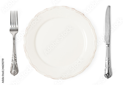 Vintage knife, fork and plate on white background