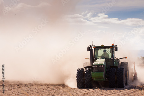 Tractor in a dusty dry farm