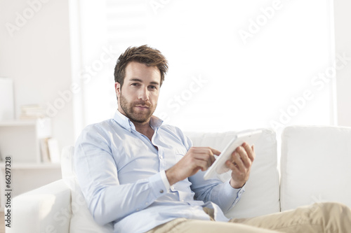handsome man surfing an tablet