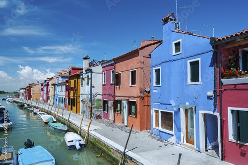 Burano island canal, colorful houses and boats, Italy. © leeyiutung