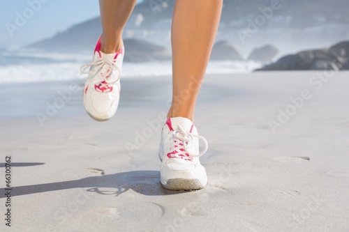 Fit woman walking on the beach