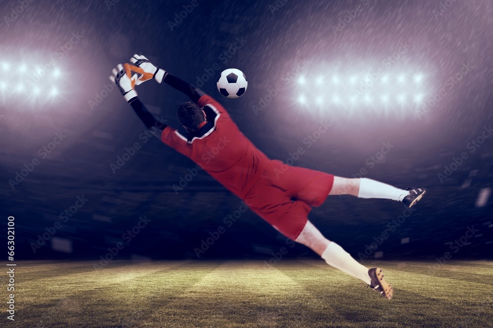 Composite image of goalkeeper in red jumping up Composite image of goalkeeper in red jumping up