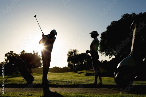 Golfing couple teeing off for the day