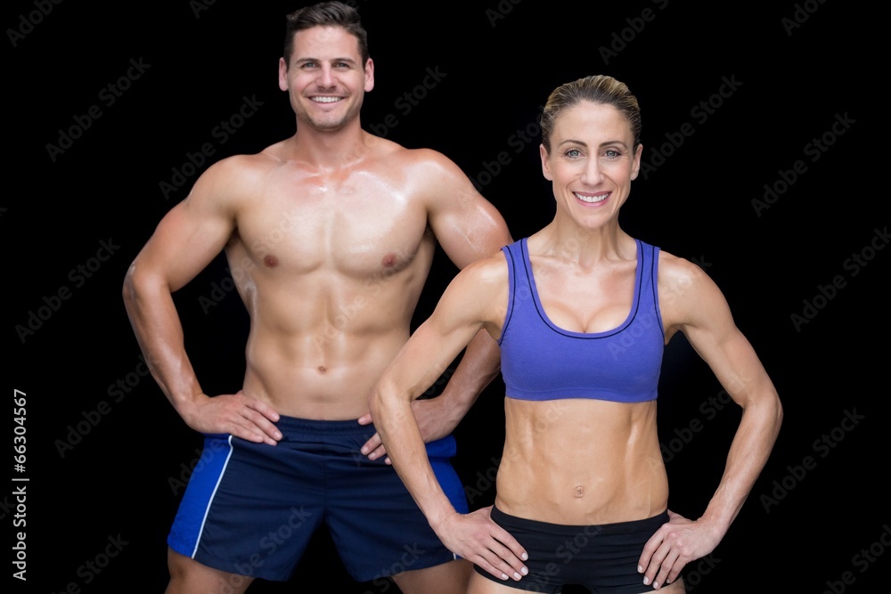 Crossfit couple smiling at camera with hands on hips Crossfit couple smiling at camera with hands on hips