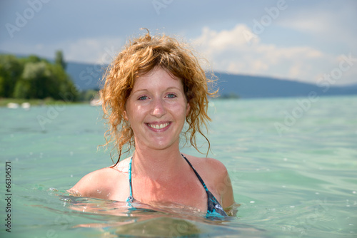 young redhead and natural bathing in a lake © Philipimage