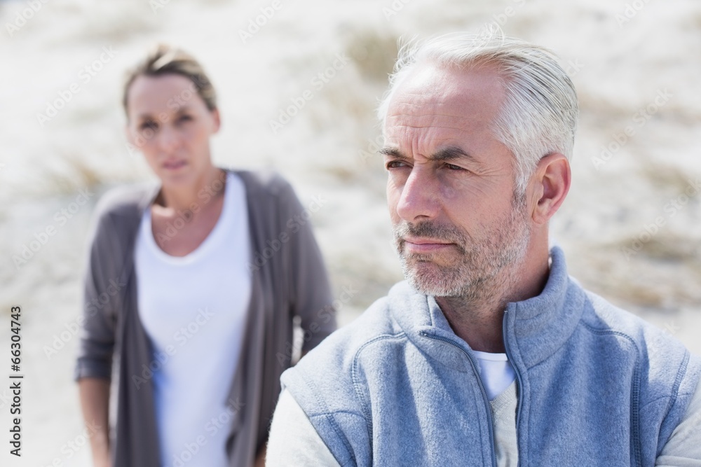 Couple not talking after argument on the beach Couple not talking after argument on the beach