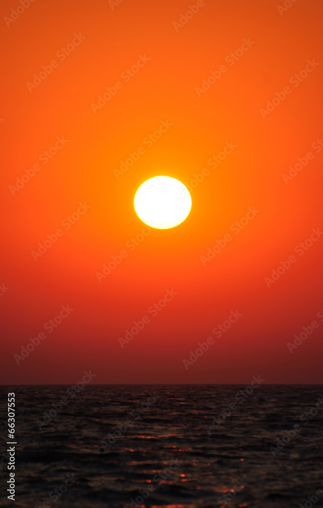 Bright vertical sunset under the sea surface