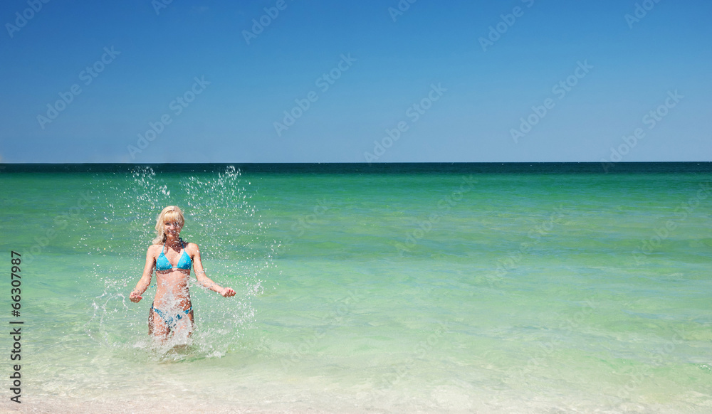 beautiful slender young woman on the sea beach