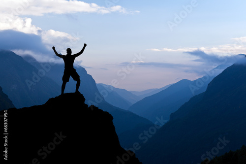 Man hiking success silhouette in mountains