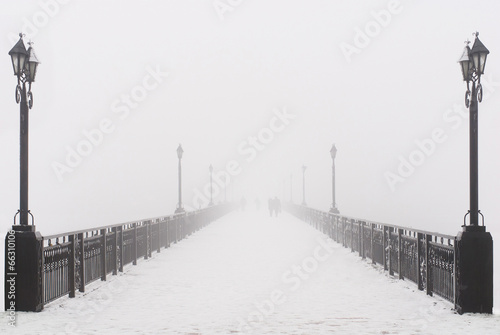 Bridge city landscape in foggy snowy winter day © EMrpize