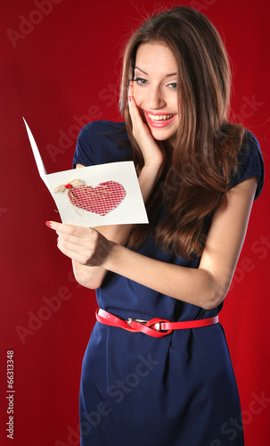 Attractive woman with postc...