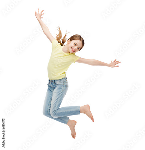 smiling little girl jumping