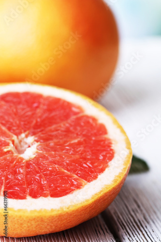 Ripe grapefruits on color wooden background