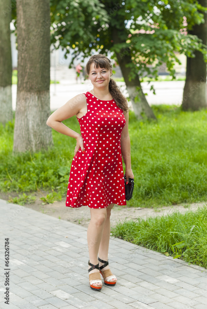 Young beautiful girl in a dress for a walk in the park. Young beautiful girl in a dress for a walk in the park.