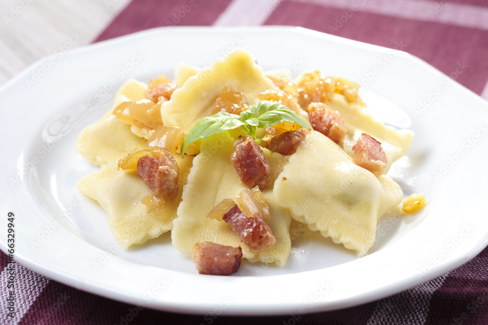 Portion of ravioli with onion and bacon