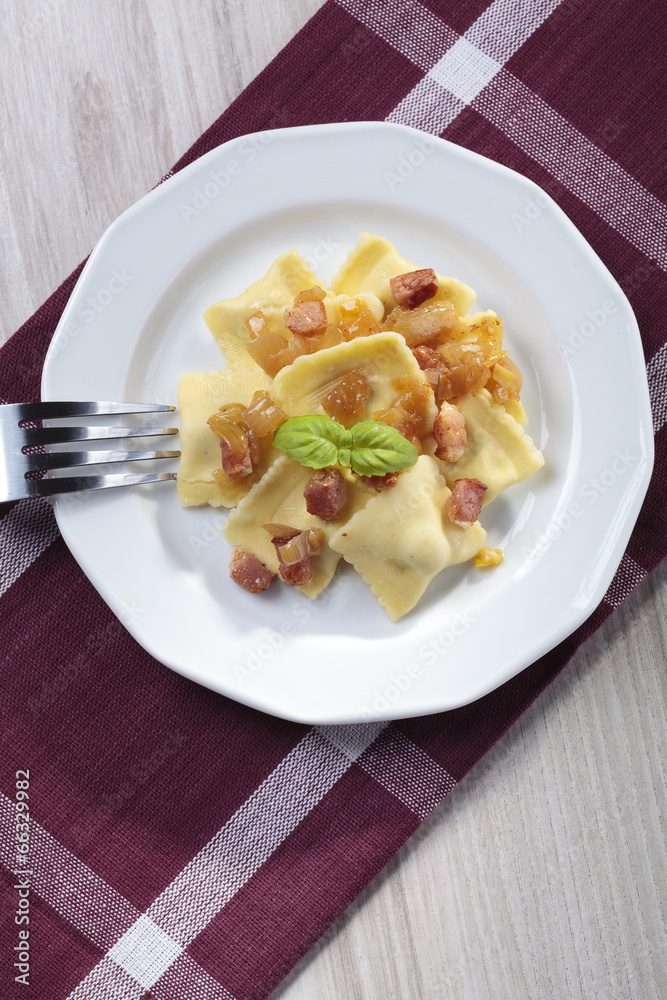 Portion of ravioli with onion and bacon