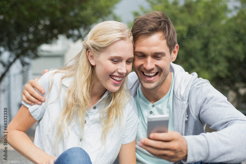 Hip young couple looking at smartphone Hip young couple looking at smartphone