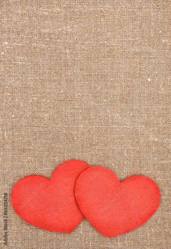 Felt red hearts on the burlap