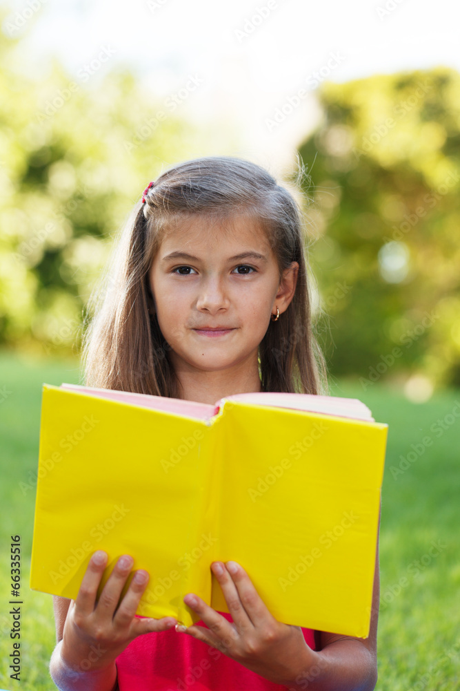 Fototapeta premium Little genius with yellow book