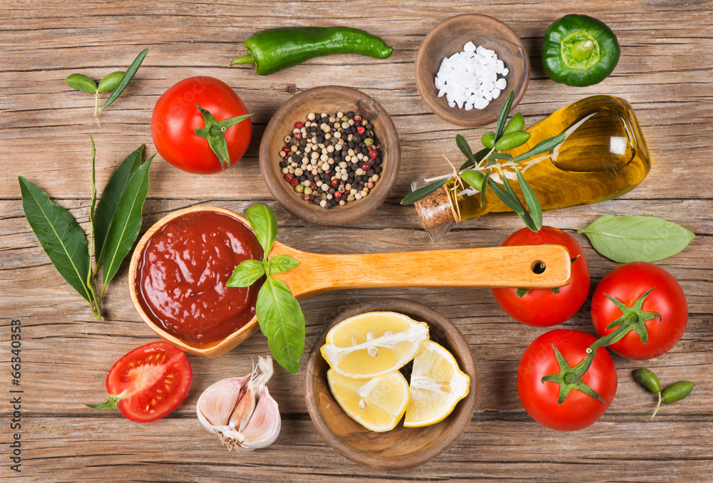 Olive oil, vegetables and spices on a brown background Olive oil, vegetables and spices on a brown background