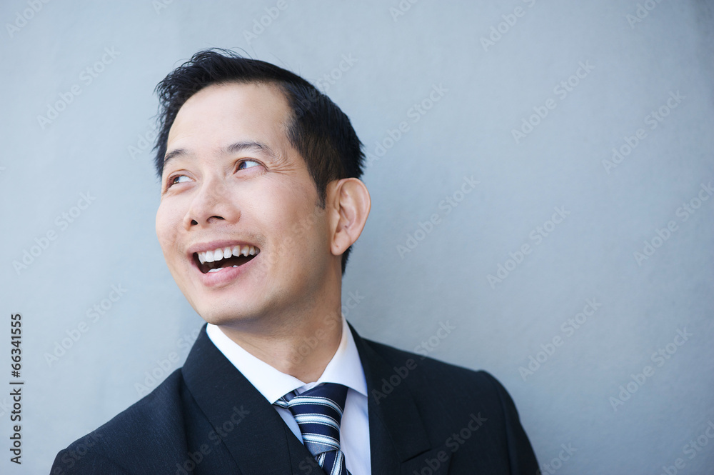 Businessman smiling on gray background Businessman smiling on gray background