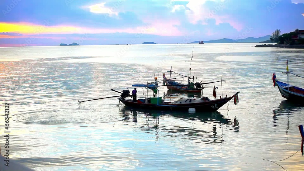 Thai fisherman prepares to sail for Fish in the sea at sunset Thai fisherman prepares to sail for Fish in the sea at sunset