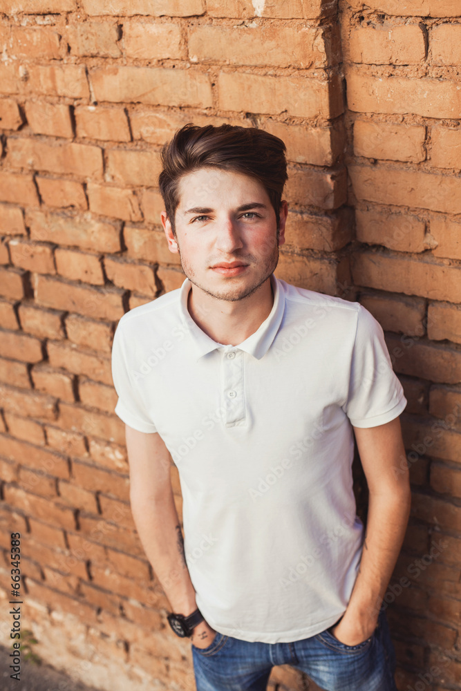 hipster young man on the brick wall