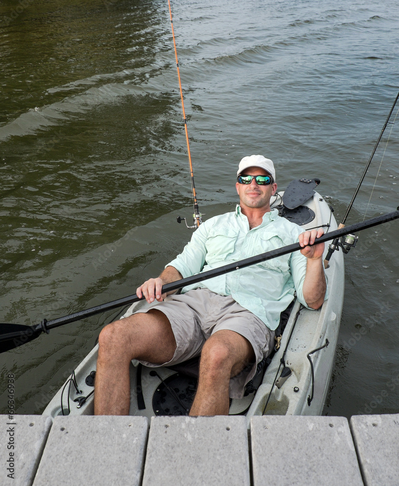 Relaxed Man Kicks Back in Fishing Kayak Relaxed Man Kicks Back in Fishing Kayak