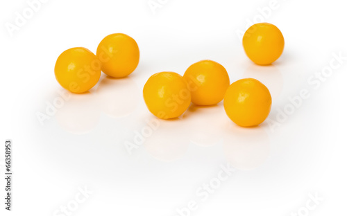 yellow vitamin pills on the white background