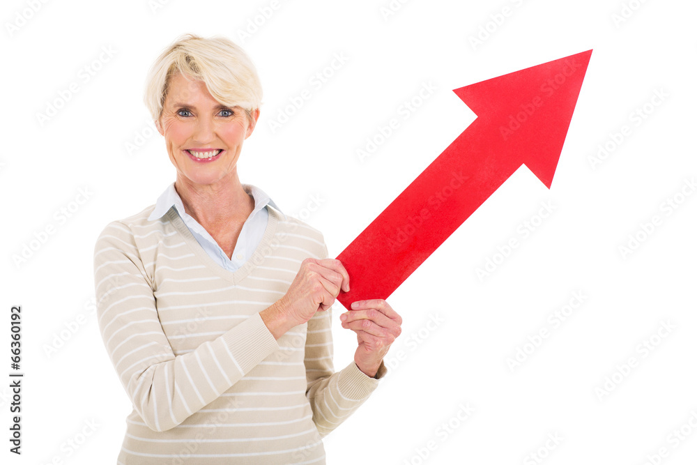 middle aged lady holding direction arrow middle aged lady holding direction arrow