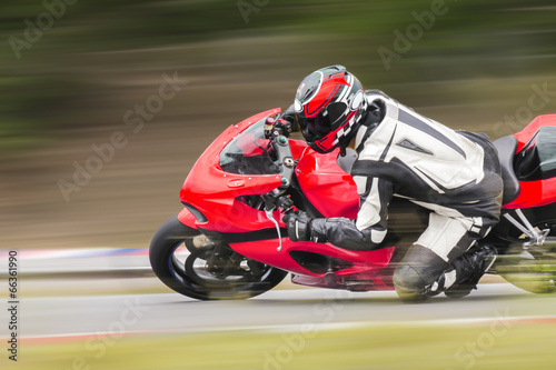 Fototapeta Motorcycle practice leaning into a fast corner on track