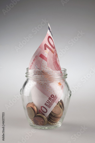 Euro money notes in a glass jar.
