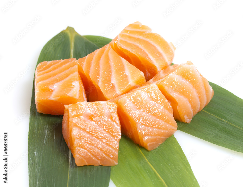 Salmon fillet on a bamboo list isolated on white background