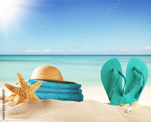 Sandy beach with accessories and blur sea