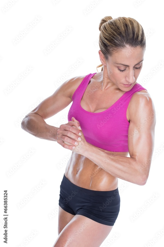 Female bodybuilder flexing with hands together Female bodybuilder flexing with hands together