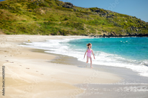 Cute little girl playing on a beach