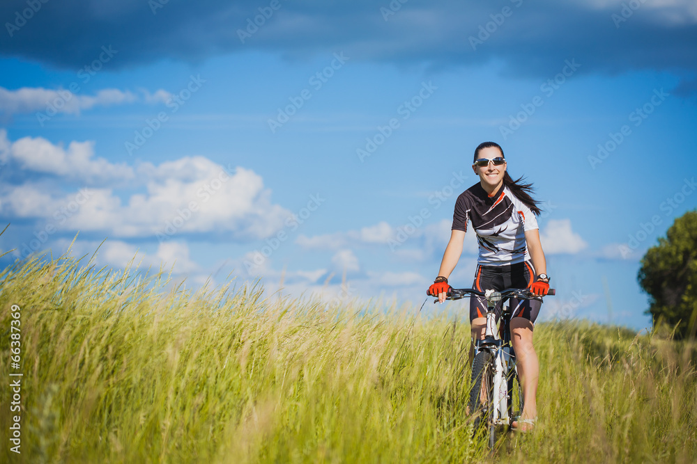 Young Woman is riding bicycle outside. Healthy Lifestyle Young Woman is riding bicycle outside. Healthy Lifestyle