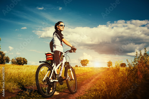 Young Woman is riding bicycle outside. Healthy Lifestyle