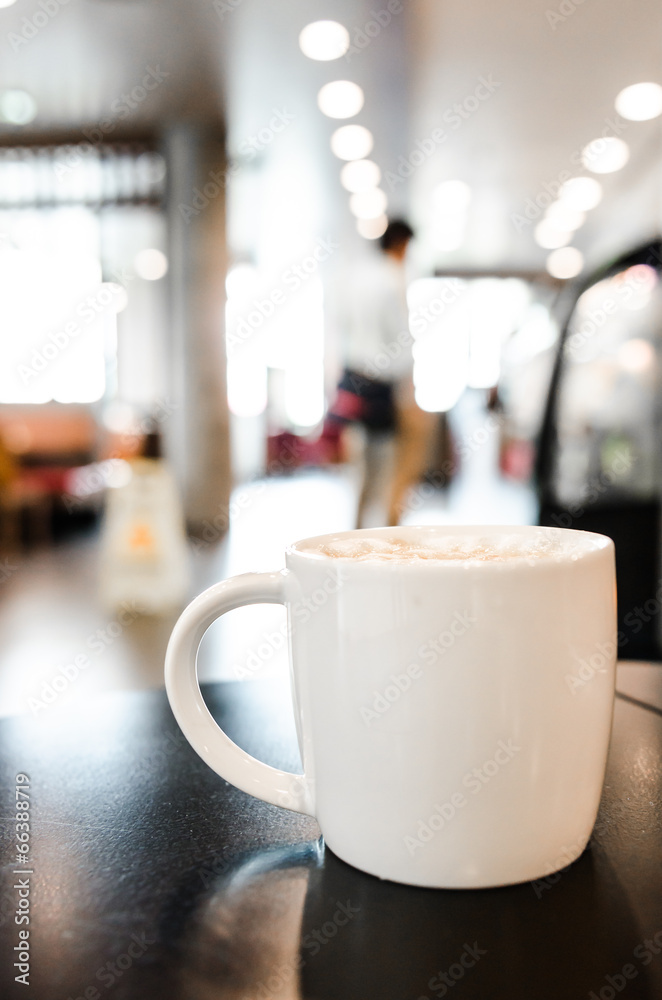 Coffee cup in coffee shop interior Coffee cup in coffee shop interior