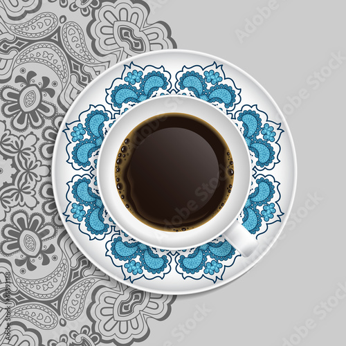 Cup of coffee and decorative ornament on a saucer and background