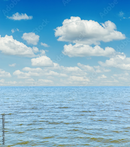 white clouds in sky over blue sea